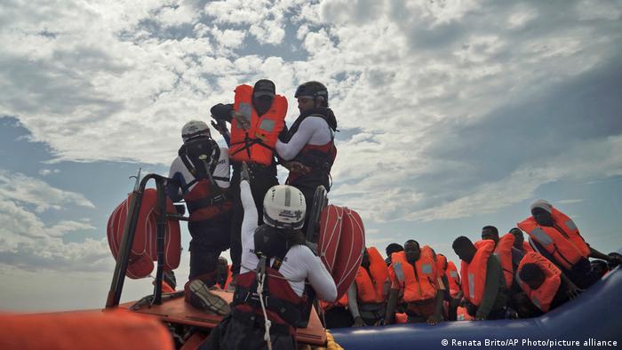A person is transferred onto a rescue boat some 14 nautical miles from the coast of Libya in Mediterranean Sea