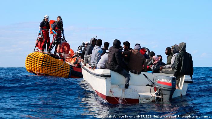 A speed boat full of would be migrants is assisted by aid workers from SOS Mediterranee off the coast of Libya