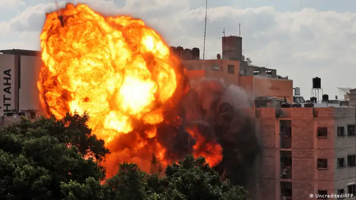 A picture taken on May 13, 2021 shows a ball of fire engulfing the Al-Walid building which was destroyed in an Israeli airstrike on Gaza city early in the morning