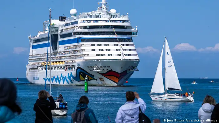 AIDA cruise ship Aidasol pictured at sea, with onlookers taking in the scene