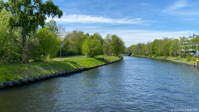 Berlin's Spree river canal with green banks as seen from a boat