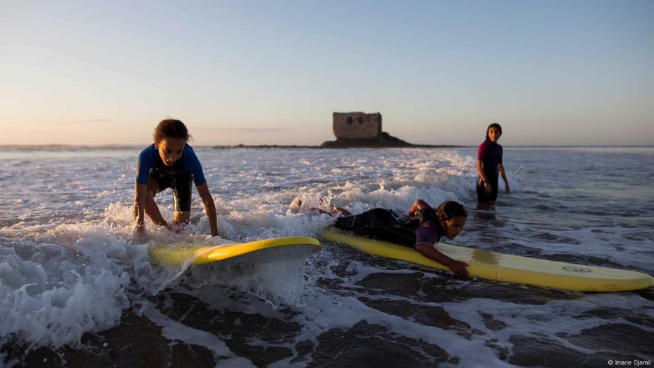 Young children surfing along Morocco's coast Young children surfing along Morocco's coast