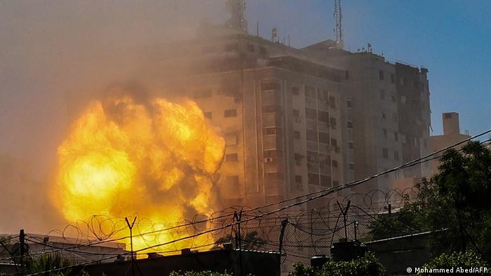 A ball of fire erupts from the Jala Tower as it is destroyed in an Israeli airstrike in Gaza City