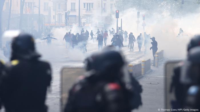 Protesters, surrounded by tear gas, face French riot mobile gendarmes during a demonstration in solidarity with Palestinians