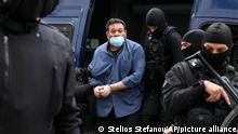 European Parliament member Ioannis Lagos leaves a police van upon his arrival at the Greek Police headquarters, in Athens, Saturday, May 15, 2021. Lagos arrived in Greece Saturday to serve a 13-year sentence imposed on him last October for being a leading member of the extreme-right Golden Dawn party, which was labeled a criminal organization. (Stelios Stefanou/InTime News via AP)