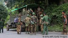 EDITORS NOTE: Graphic content / Armed government troops arrive outside the Gote Twin police station in Shan State on August 15, 2019, after it was attacked by ethnic rebel groups. - At least 14 have been killed in ongoing fighting on August 15 between Myanmar's military and rebels who mounted a series of attacks, including an unprecedented strike on an army academy, apparently in retaliation for massive drug seizures. (Photo by STR / AFP) (Photo credit should read STR/AFP via Getty Images)