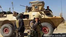 05.05.2021***(FILES) In this file photo taken on May 05, 2021 Afghan security forces stand near an armoured vehicle during ongoing fighting between Afghan security forces and Taliban fighters in the Busharan area on the outskirts of Lashkar Gah, the capital city of Helmand province. - The US military has deployed more heavy bombers and fighter jets to protect withdrawing American and coalition troops from Afghanistan, which have so far sustained no direct attacks, the Pentagon said May 6, 2021. (Photo by Sifatullah ZAHIDI / AFP)
