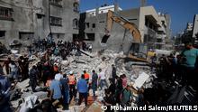 16.05.21 *** Rescue workers search for victims amid rubble at the site of Israeli air strikes, in Gaza City May 16, 2021. REUTERS/Mohammed Salem