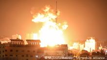 GAZA CITY, GAZA - MAY 17: Smokes and flames rise after airstrikes by Israeli army hit buildings in Gaza City, Gaza on May 17, 2021. Mustafa Hassona / Anadolu Agency