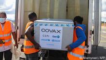 Workers load boxes of Oxford/AstraZeneca Covid-19 vaccines, part of the the Covax programme, which aims to ensure equitable access to Covid-19 vaccinations, into a truck after they arrived by plane at the Ivato International Airport in Antananarivo, Madagascar, on May 8, 2021. (Photo by Mamyrael / AFP)