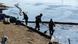 Workers in protective clothes cleaning up an oil spill from the river Workers in protective clothes cleaning up an oil spill from the river