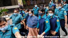 Bangladeshi journalist Rozina Islam, center, is escorted by police to a court in Dhaka, Bangladesh, Tuesday, May 18, 2021. Police in Bangladesh's capital have arrested the prominent journalist on charges of stealing and photographing sensitive state information. (AP Photo/Mahmud Hossain Opu)
