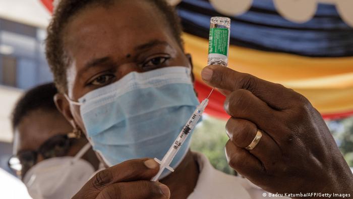  Health worker administering a vaccine in Kampala, Uganda