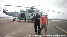 This photograph provided by Indian navy shows, one of the men rescued by the navy from the Arabian sea being brought for medical attention at naval air station INS Shikra in Mumbai, India, Tuesday, May 18, 2021. The Indian navy is working to rescue crew members from a sunken barge and a second cargo vessel that was adrift Tuesday off the coast of Mumbai after Cyclone Tauktae, struck the western coast. (Indian Navy via AP)