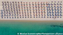 Greece opens for tourism since May 14 and the country is ready to receive the first tourism wave keeping all the COVID protocols in action. The country began easing the lockdown and curfew measures, opened the shops, bars and restaurants with strict rules. Aerial bird's eye panoramic view from a drone of beaches around the villages of Halkidiki area. The beach with the golden sand and transparent crystal-clear emerald water, exotic style just in front of the houses of Pefkohori and Potidea, typical for the Aegean Sea and the Mediterranean. Chalkidiki has a long coastline and is a popular destination for tourists and locals having hidden treasures, beach bars and parties in front of the sea or locations without the overcrowded summer scenes. The area is famous for the best beaches in the country in a driving distance, near the city of Thessaloniki. Greece is pushing for a COVID vaccination passport and the European Commission adopted the proposal, so the country can receive tourists during the seasonal tourism period. The coronavirus pandemic hit hard the Greek tourism related businesses, economy and travel industry. Potidea - Halkidiki, Greece May 16, 2021 (Photo by Nicolas Economou/NurPhoto)