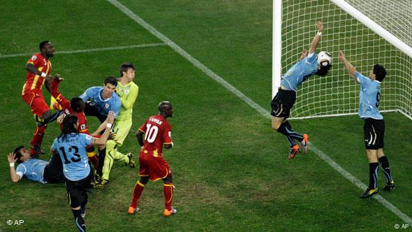 Uruguay's Luis Suarez, right, reaches his hands to the ball to give away a penalty during the World Cup quarterfinal soccer match between Uruguay and Ghana at Soccer City in Johannesburg, South Africa, Friday, July 2, 2010.