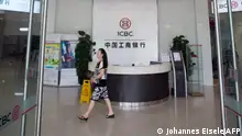 This picture taken on September 24, 2014 shows a woman walks in an Industrial and Commercial Bank of China Ltd (ICBC) branch in the China (Shanghai) Pilot Free Trade zone during a media trip. Concerns over China's economy -- a key driver of global growth -- have intensified following a string of lacklustre recent data, with economists calling for authorities to take further action to kickstart growth. AFP PHOTO / JOHANNES EISELE (Photo by JOHANNES EISELE / AFP)