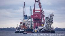 Jan. 14, 2021, ++++ file photo, tugboats get into position on the Russian pipe-laying vessel Fortuna in the port of Wismar, Germany. The special vessel is being used for construction work on the German-Russian Nord Stream 2 gas pipeline in the Baltic Sea. Pressure is growing on President Joe Biden to take action to prevent the completion of a Russian gas pipeline to Europe that many fear will give the Kremlin significant leverage over U.S. partners and allies. (Jens Buettner/dpa via AP)