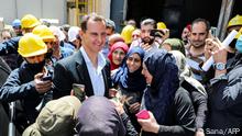 ++++Propagandamaterial - bitte kennzeichnen+++A handout picture released by the official Syrian Arab News Agency (SANA) on May 3, 2021 shows Syrian President Bashar al-Assad (C-L) being met by local workers during a visit to the industrial area of Syria's west-central town of Hisya. (Photo by - / SANA / AFP) / == RESTRICTED TO EDITORIAL USE - MANDATORY CREDIT AFP PHOTO / HO / SANA - NO MARKETING NO ADVERTISING CAMPAIGNS - DISTRIBUTED AS A SERVICE TO CLIENTS ==