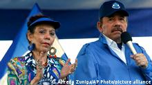 FILE - In this Sept. 5, 2018 file photo, Nicaragua's President Daniel Ortega and his wife, Vice President Rosario Murillo, lead a rally in Managua, Nicaragua. Despite the new Feb. 1, 2019 tax rises, Nicaragua has not seen a repeat of last year’s mass protests. And it seems unlikely to, since Ortega forcefully quashed the challenge to his power, including effectively outlawing opposition demonstrations since September. (AP Photo/Alfredo Zuniga, File)