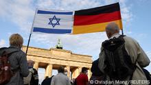 People carry an Israeli and a German flag during a rally in solidarity with Israel and against antisemitism, in front of the Brandenburg Gate in Berlin, Germany, May 20, 2021. REUTERS/Christian Mang