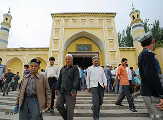 Uygurs leave Id Kah Mosque after offering Friday prayers in Kashgar in northwest China's Xinjiang Uygur Autonomous Region, Friday, July 2, 2010. Long-simmering tensions between Xinjiang's minority Uighurs and majority Han Chinese migrants turned into open violence in the streets of Urumqi, the capital of the traditionally Muslim region, last July. The government said 197 people were killed. (AP Photo/Kyodo News) ** JAPAN OUT, MANDATORY CREDIT, FOR COMMERCIAL USE ONLY IN NORTH AMERICA **