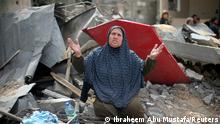 A Palestinian woman reacts after returning to her destroyed house following Israel-Hamas truce, in Gaza May 21, 2021. REUTERS/Ibraheem Abu Mustafa