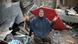 A woman kneels next to a building that was destroyed by airstrikes A woman kneels next to a building that was destroyed by airstrikes