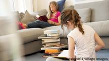 Two girls sitting in the living room reading books model released Symbolfoto property released PUBLICATIONxINxGERxSUIxAUTxHUNxONLY NEKF00041 
