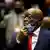 Former South African president Jacob Zuma pulls down his face mask