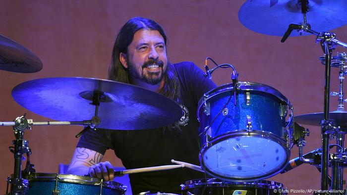 Dave Grohl grinning behind the drums.