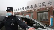 Security guard check at the gate of Wuhan Institute of Virology as a vehicle carrying the experts of World Health Organization (WHO) entered in Wuhan, Hubei Province, China on Feb. 3rd, 2021. WHO probe team members tackled to investigate into the origins of the Covid-19 pandemic. ( The Yomiuri Shimbun via AP Images )