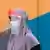 Weltspiegel | Malaysia, Sungai Buloh | Frau mit Maske und Faceshield im Test Zentrum 