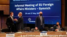 Ireland's Foreign Minister Simon Coveney, center, waits for the start of a round table meeting of EU foreign ministers in Lisbon, Thursday, May 27, 2021. European Union foreign ministers meet Thursday to discuss EU-Africa relations and Belarus. (AP Photo/Armando Franca)