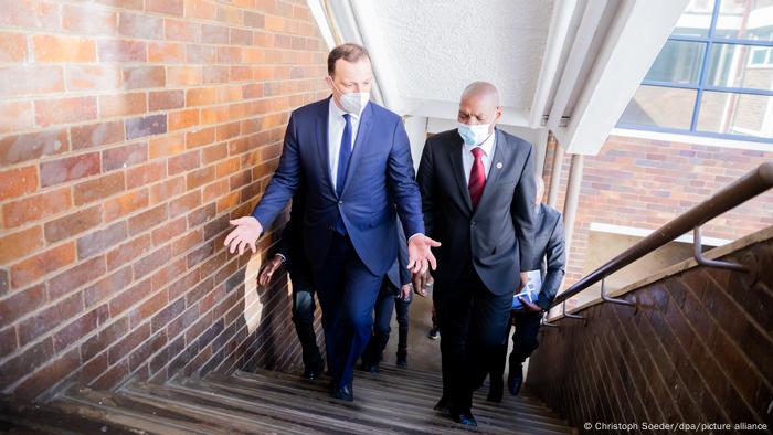 Germany's Health Minister Jens Spahn speaks with his South African counterpart, Zweli Mkhize on the stairs