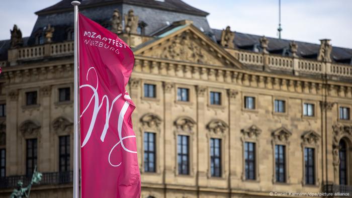 A pink flag fluttering in front of a palace