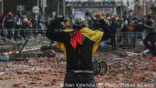 Anti-government protesters clash with police in Madrid, on the outskirts of Bogota, Colombia, Friday, May 28, 2021. Colombians have taken to the streets for weeks across the country after the government proposed tax increases on public services, fuel, wages and pensions. (AP Photo/Ivan Valencia)