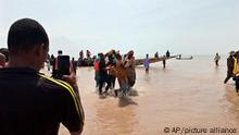 In this photo released by National Emergency Management Agency, rescued workers carry a victim of a boat accident in wara Kebbi , Nigeria, Thursday, May 27, 2021. More than 100 people are missing and feared dead after a boat with more than 165 passengers, including women and children, broke and sank as it was traveling in Nigeria's northern Kebbi state, officials said Wednesday.(National Emergency Management Agency/via AP)