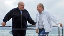 Russian President Vladimir Putin, right, and Belarusian President Alexander Lukashenko talks to each other standing on the boat during their meeting in the Black Sea resort of Sochi, in Russia, Saturday, May 29, 2021.(Sergei Ilyin, Sputnik, Kremlin Pool Photo via AP)