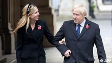(FILES) In this file photo taken on November 8, 2020 Britain's Prime Minister Boris Johnson (R) and his parter Carrie Symonds (L) meet veterans at the Remembrance Sunday ceremony at the Cenotaph on Whitehall in central London. - Johnson married his fiancee Carrie Symonds married in a secret ceremony on May 29, 2021, UK media reports said. (Photo by Chris Jackson / POOL / AFP)