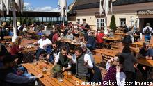 ANDECHS, GERMANY - MAY 22: People sit in a beer garden at Andechs monastery for the first time this year during the coronavirus pandemic on May 22, 2021 in Andechs, Germany. Authorities are easing lockdown measures across Germany, enabling restaurants to offer outdoor service, hotels to accommodate tourists, cultural institutions to perform and other activities to resume. Covid infection rates have been falling consistently and the national average is now below 80 per 100,000 over a seven-day period. Meanwhile the pace of vaccinations is still climbing, with approximately 40% of the population having received a first dose. (Photo by Andreas Gebert/Getty Images)