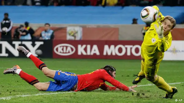 Spain's Sergio Ramos, left, tries to score a goal past Germany goalkeeper Manuel Neuer, right.