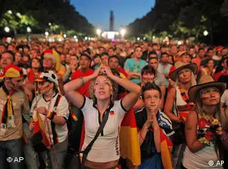 German fans react watching the World Cup soccer match between Germany and Spain at a public viewing area in Berlin