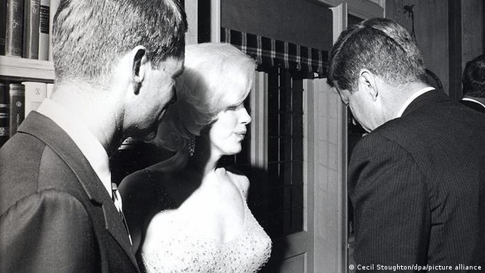 Marilyn Monroe in tight dress, with Bobby Kennedy and President John F. Kennedy.