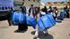 Afghan refugees carrying free aid distributed by the IOM