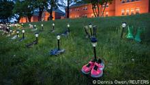 Pairs of children's shoes and toys are seen at memorial in front of the former Kamloops Indian Residential School after the remains of 215 children, some as young as three years old, were found at the site last week, in Kamloops, British Columbia, Canada May 31, 2021. REUTERS/Dennis Owen