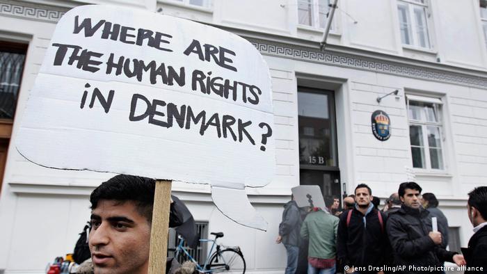 Some thirty Syrian refugees from different camps seeking asylum hold banners outside the Swedish Embassy in Copenhagen, Denmark