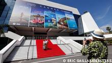 People pose on the red carpet of the Festival palace in Cannes as the French Riviera prepares for the 2021 edition of the Cannes Film Festival which will take place next July, in France, June 3, 2021. REUTERS/Eric Gaillard