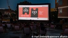 Werbung für die Berlinale ist auf der Leinwand im Freiluftkino am Kulturforum zu sehen. Zahlreiche Menschen sitzen am Kulturforum am Potsdamer Platz im Freiluftkino. Das Kino ist eine der Spielstätten bei der diesjährigen Berlinale. +++ dpa-Bildfunk +++