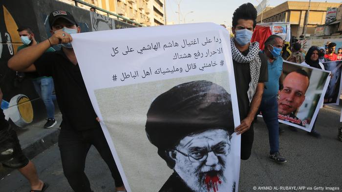 Iraqi demonstrators attend a symbolic funeral for slain Iraqi jihadism expert Hisham al-Hashemi.